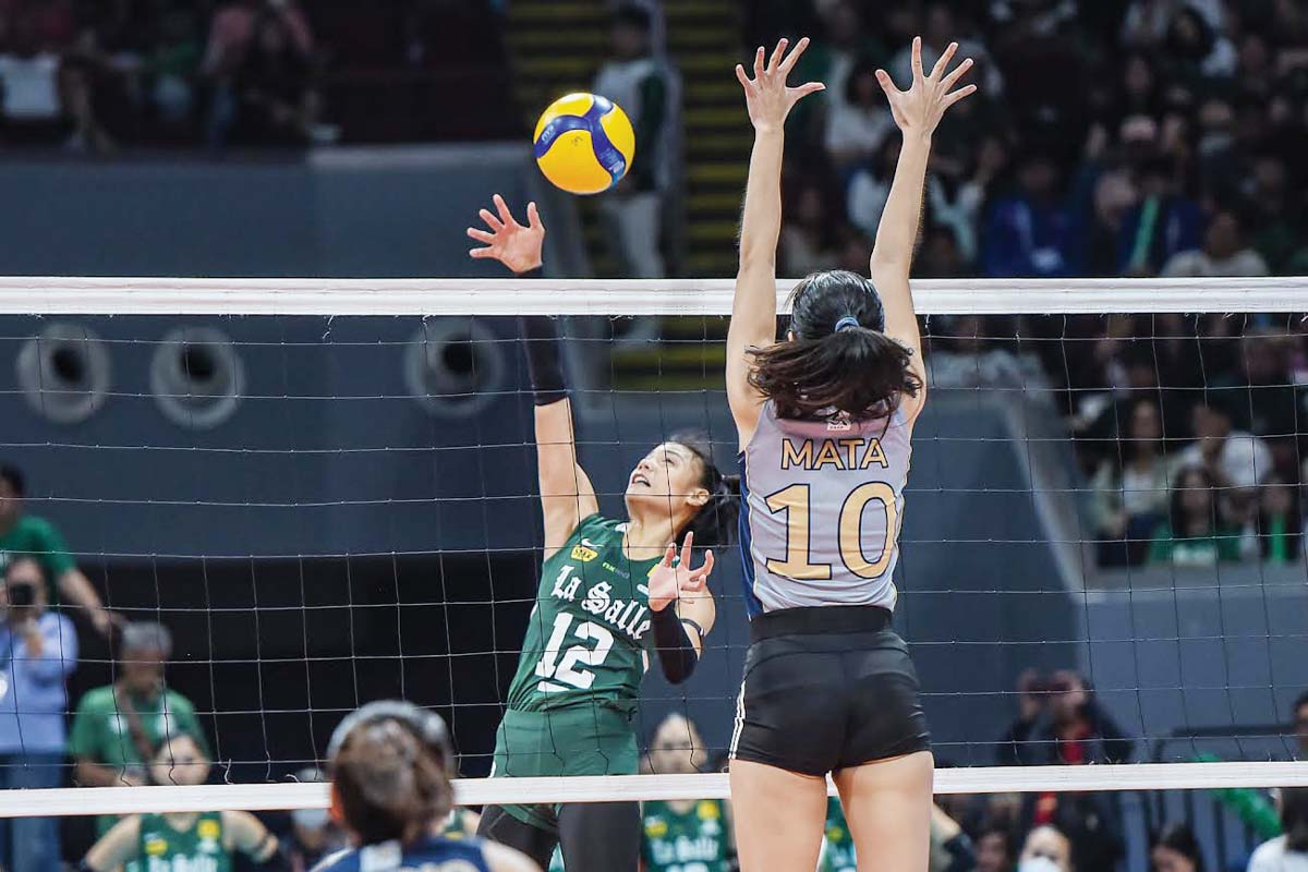 Negrense Angel Canino of the De La Salle University Lady Spikers tries to score against the defense of National University Lady Bulldogs’ Alexa Mata. (UAAP photo) 