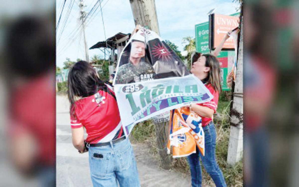 Commission on Elections (Comelec) personnel in Negros Oriental take down illegal campaign materials at the start of the campaign period for national candidates on Tuesday, February 11, 2025. The Comelec will conduct regular removal of illegal posters until election day on May 12. (PNA photo)