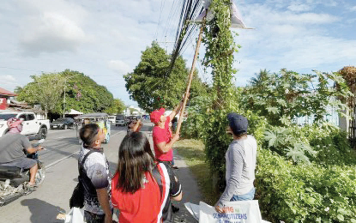 Commission on Elections personnel in Negros Oriental removed campaign posters illegally placed on an electric post on February 11, 2025. The poll body is urging local candidates to take down illegal campaign materials before the start of the campaign period for local candidates on March 28, 2025. (PNA photo)