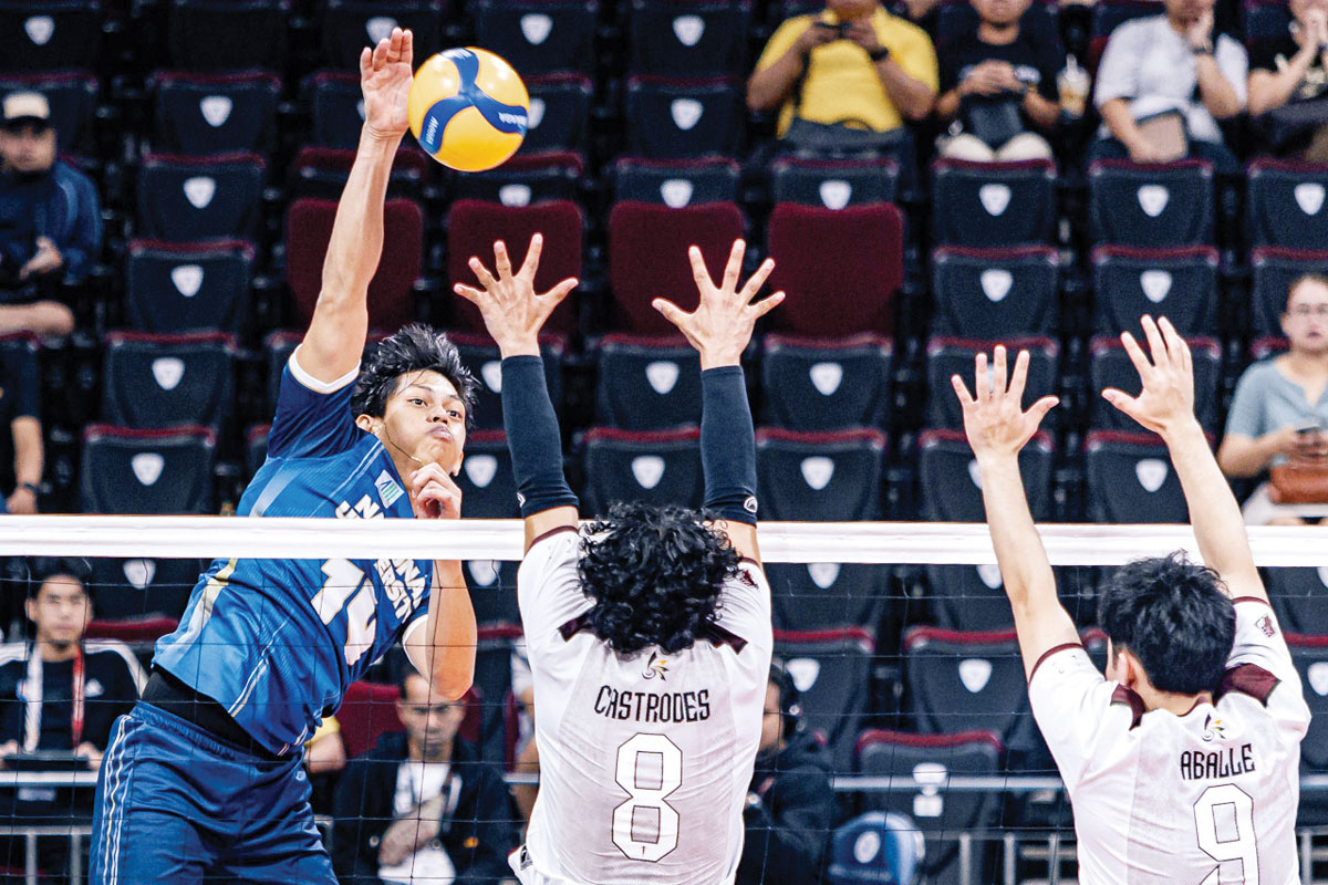 Negrense Leo Ordiales of the National University Bulldogs scores against the defense of the University of the Philippines Fighting Maroons. (UAAP photo)