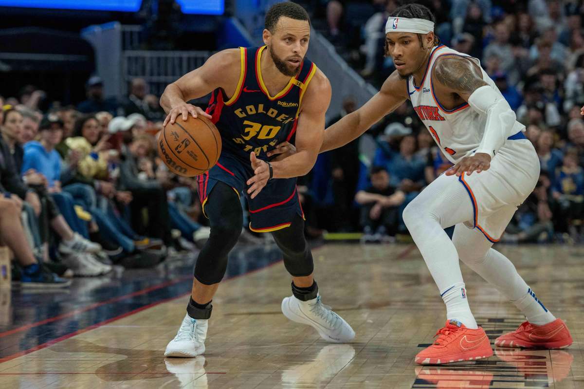 Golden State Warriors guard Stephen Curry dribbles the basketball against New York Knicks guard Miles McBride. (Neville E. Guard-Imagn Images / Reuters photo)