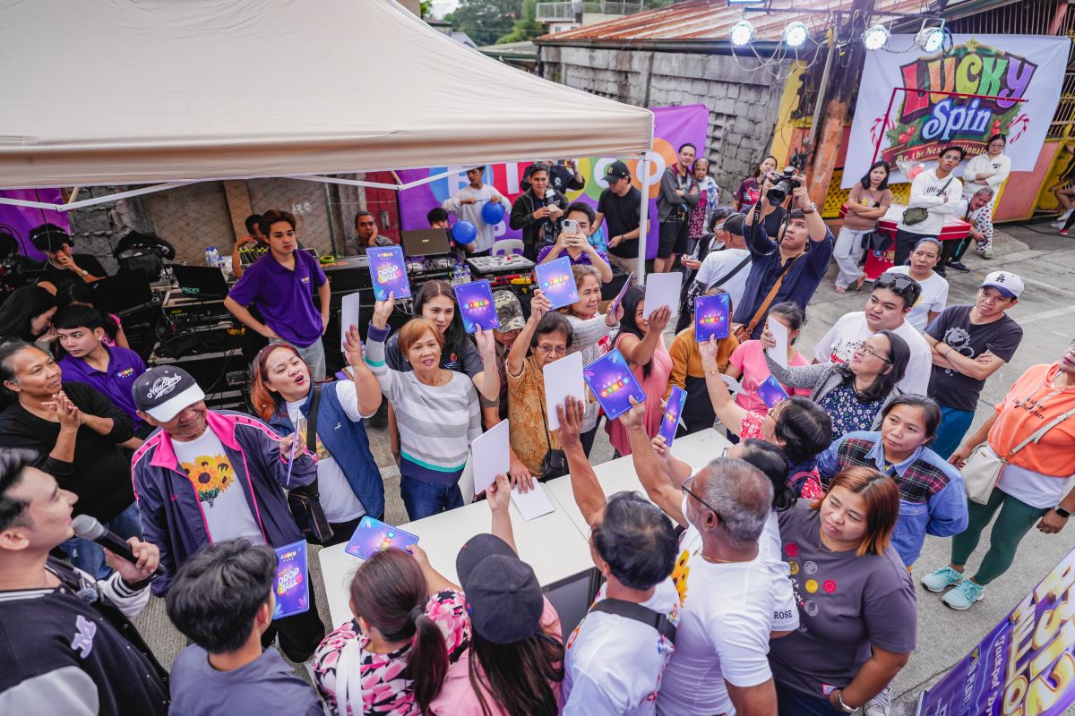 Residents participating in a game brought by BingoPlus at the Lucky Spin Community Fiesta.