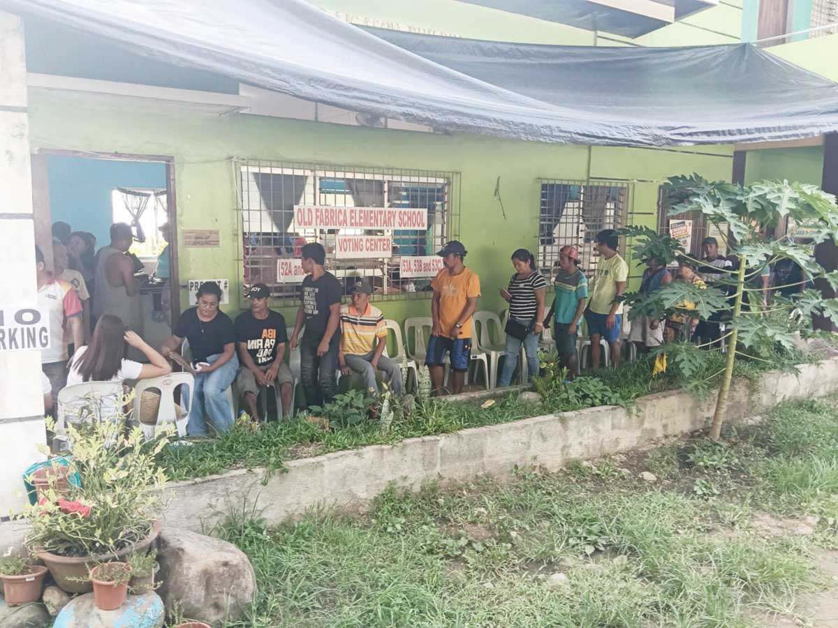 A total of 2,349 registered voters from Barangay Cabagna-an, recently affected by Kanlaon Volcano’s unrest in Negros Occidental’s La Castellana town, wait in line to cast their votes at the La Castellana National High School during the midterm elections yesterday, May 12, 2025.  (Remuel Lajo / La Castellana PIO photo)