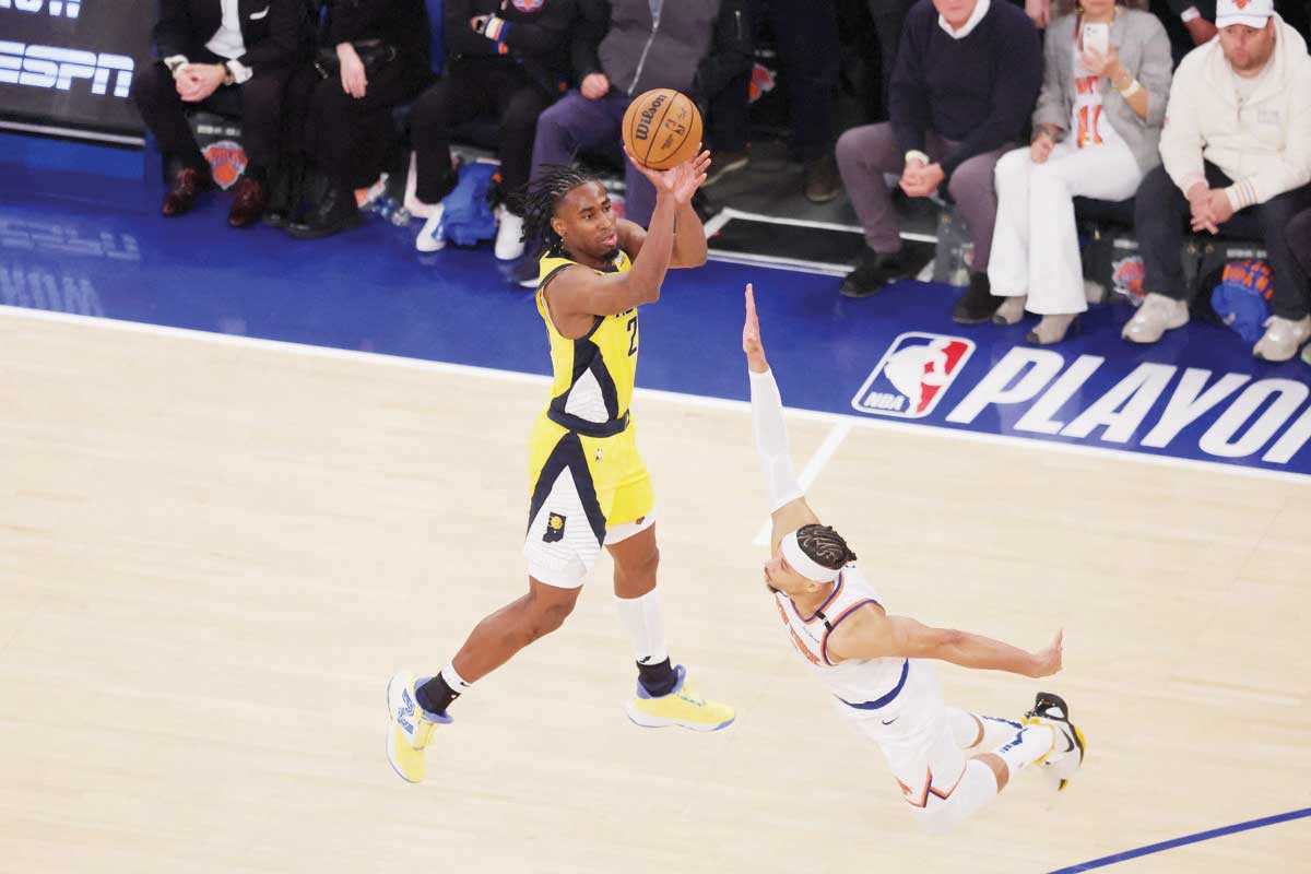 Indiana Pacers forward Aaron Nesmith (left) shoots a three-point shot against New York Knicks guard Josh Hart in Game 1 of the Eastern Conference finals for the 2025 NBA Playoffs. (Brad Penner / Imagn Images / Reuters)