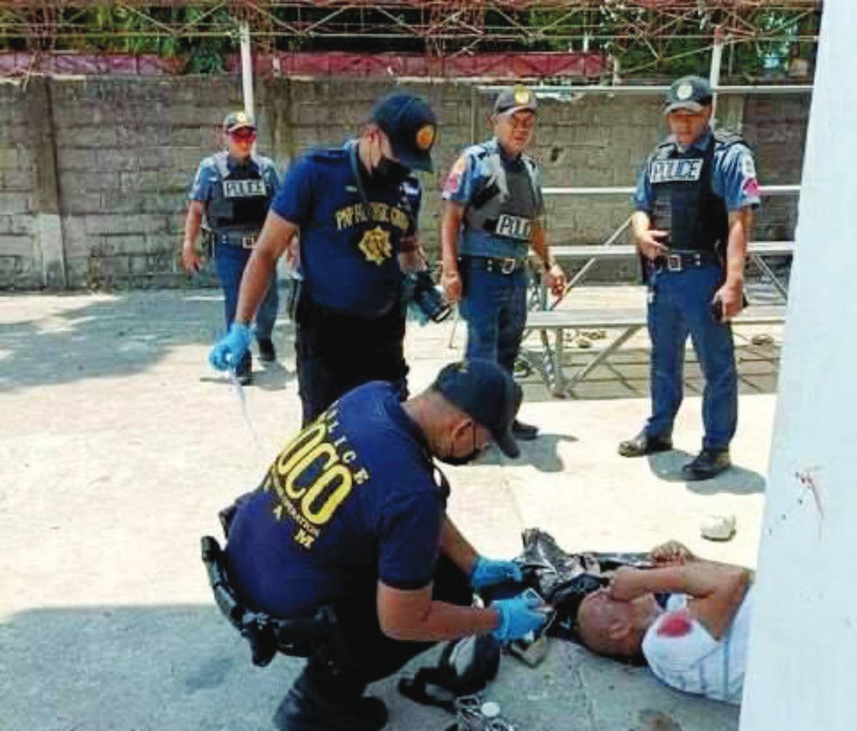 Police investigate the scene where businessman Philip George Vail Sr., chairman of the board of Dancalan Private Academy, was shot dead at Dancalan public plaza in Negros Occidental’s Ilog town on August 5, 2025. (PRO-NIR photo)