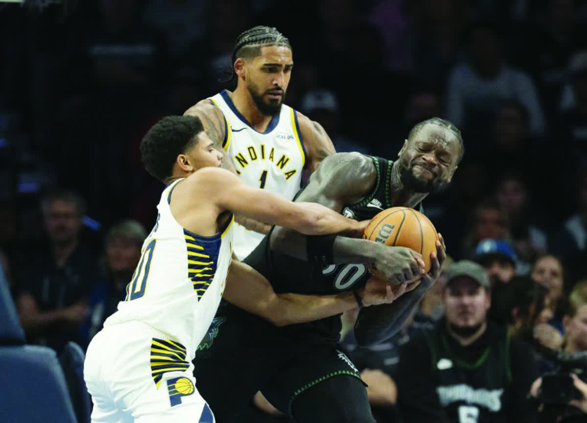 Minnesota Timberwolves forward Julius Randle (right) fights to keep control of the ball from Indiana Pacers RayJ Dennis (left) and Obi Toppin. (Jesse Johnson / Imagn Images / Reuters)