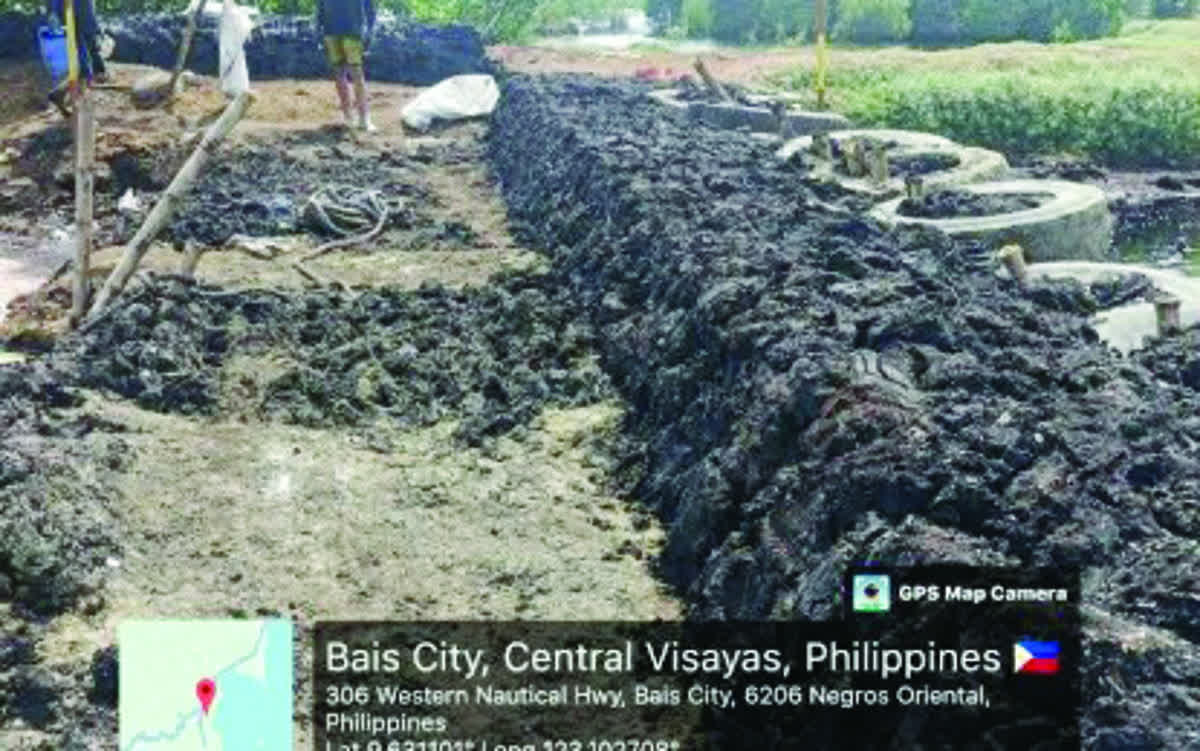 The portion of the containment lagoon of the URC Bais Distillery in Bais City, Negros Oriental nears completion in this photo taken on November 11, 2025. The Department of Environment and Natural Resources has filed complaints against the firm in relation to the wastewater spillage from the breached lagoon last month. (Coast Guard Station - Negros Oriental / File photo)