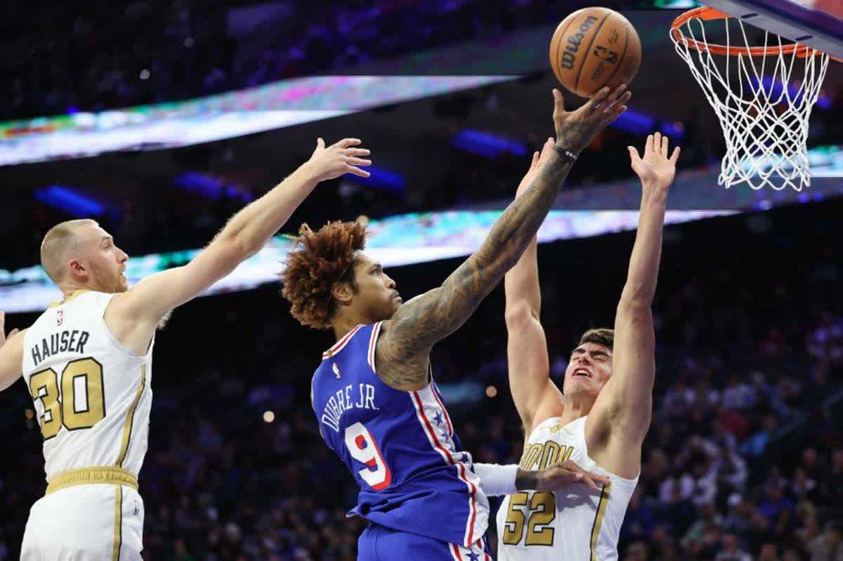 Philadelphia 76ers guard Kelly Oubre, Jr. (center) drives for a shot against Boston Celtics center Luka Garza (right) and forward Sam Hauser. (Bill Streicher / Imagn Images / Reuters)
