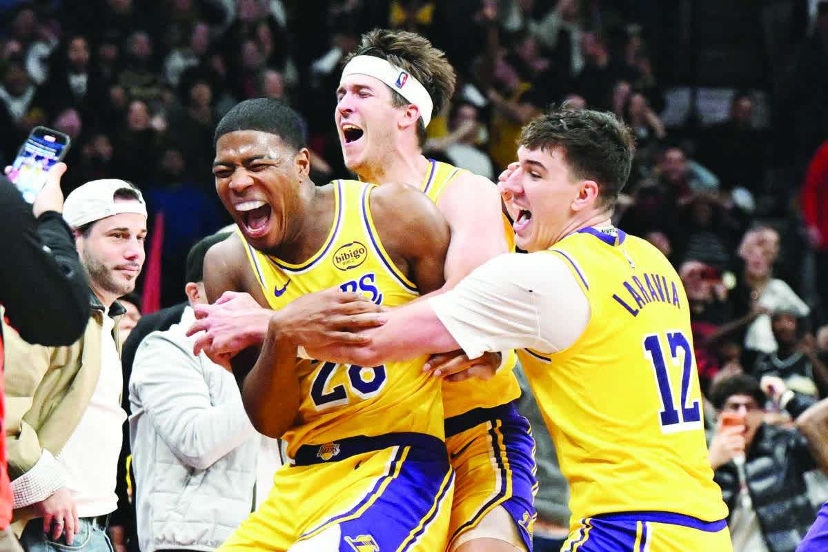 Los Angeles Lakers forward Rui Hachimura (28) celebrates with Jake LaRavia (12) and Austin Reaves after scoring the game-winning basket. (Dan Hamilton / Imagn Images / Reuters)
