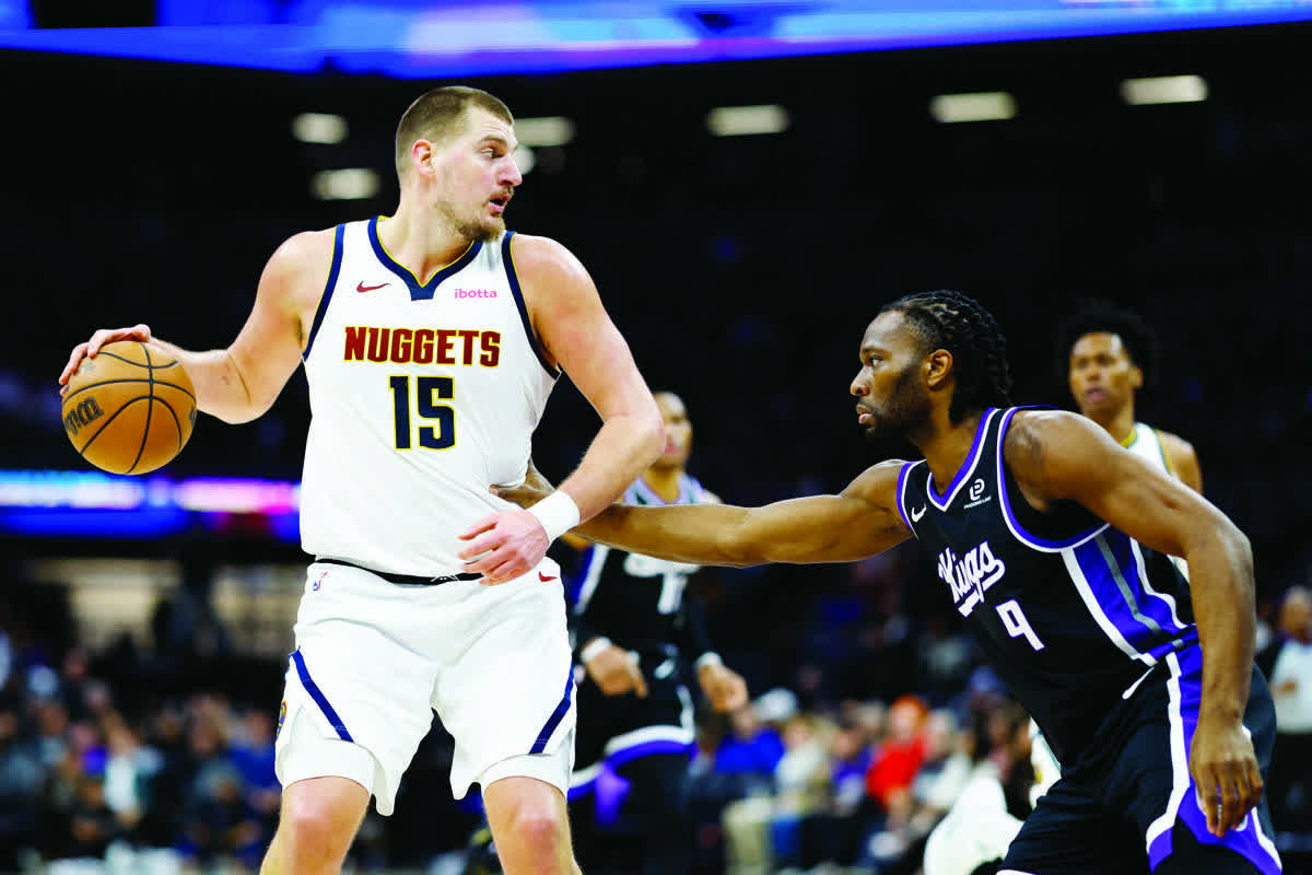 Denver Nuggets center Nikola Jokic (left) dribbles the ball against Sacramento Kings forward Precious Achiuwa. (Sergio Estrada / Imagn Images)