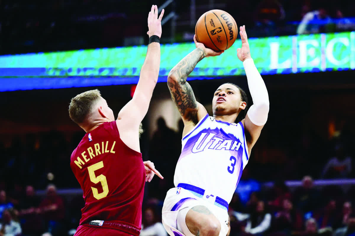 Utah Jazz guard Keyonte George (right) shoots over the defense of Cleveland Cavaliers guard Sam Merrill. (Ken Blaze / Imagn Images)