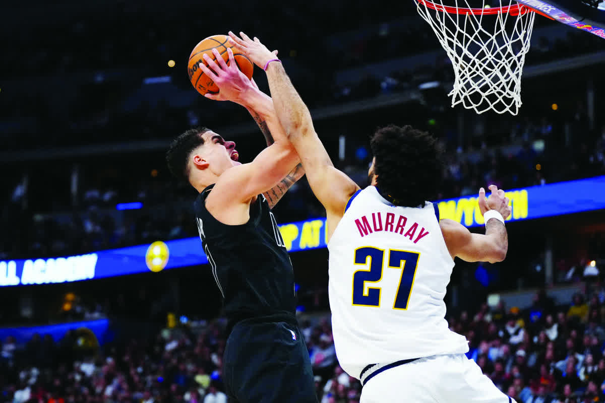 Brooklyn Nets forward Michael Porter, Jr. (left) shoots the ball over Denver Nuggets guard Jamal Murray. (Ron Chenoy / Imagn Images)