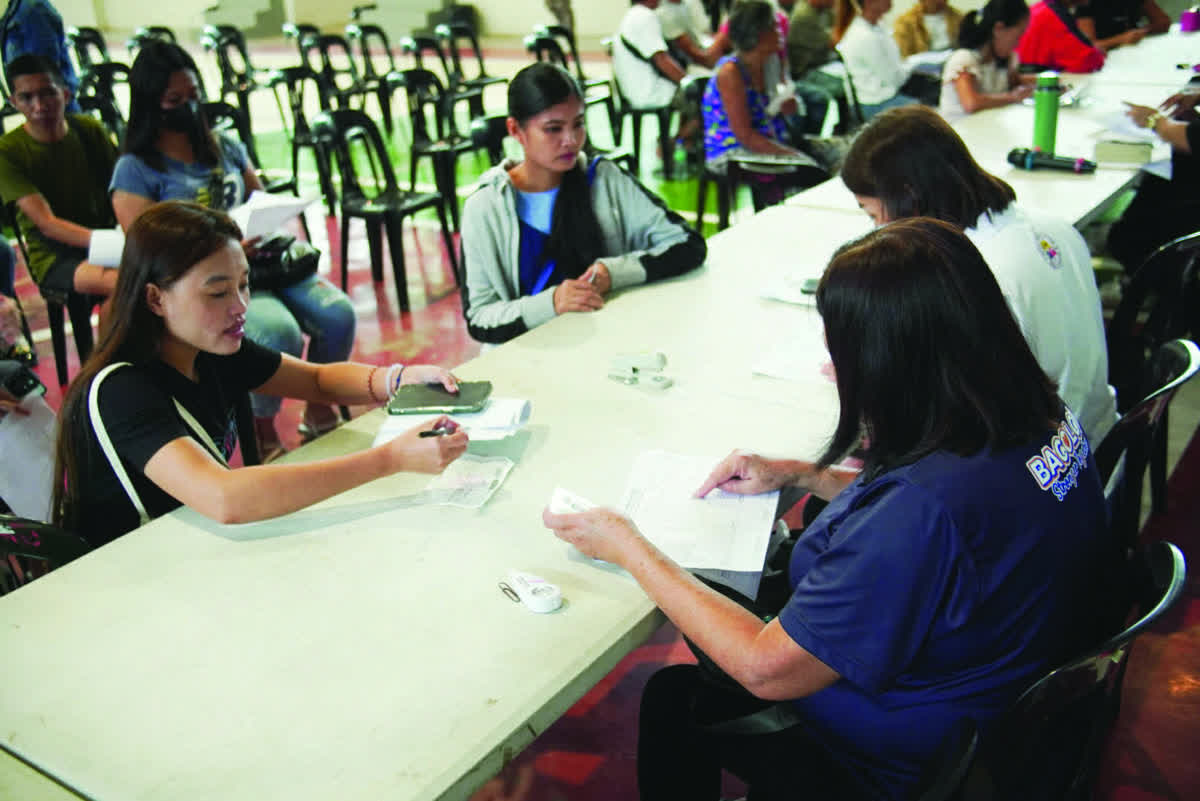 Residents affected by recent fire incidents receive cash assistance at the Bacolod City College gymnasium yesterday, February 3, 2026. The city government is also fast-tracking the additional development of its relocation site for families displaced by fire and for those living in danger zones. (Bacolod City Communications Office photo)