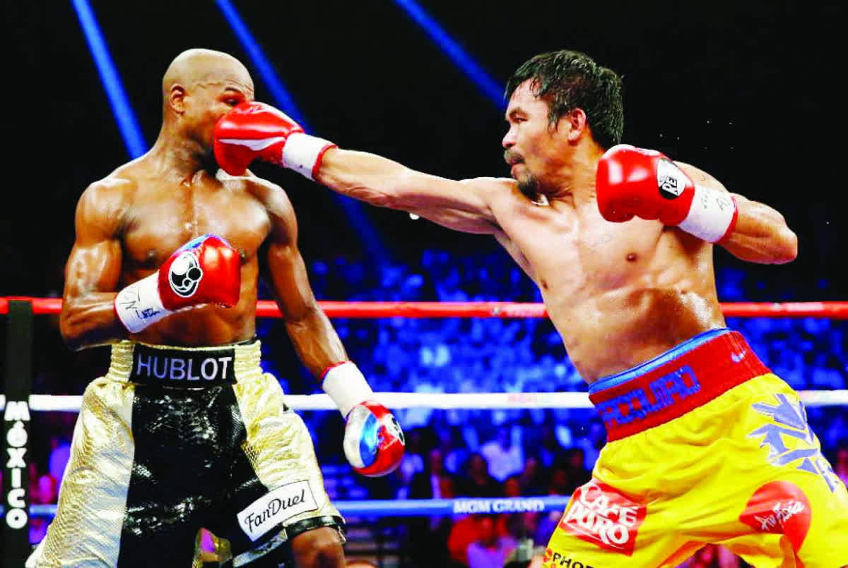 Manny Pacquiao throws a right at Floyd Mayweather, Jr. during their welterweight unification championship bout on May 2, 2015, at MGM Grand Garden Arena in Las Vegas, Nevada. (Al Bello / Getty Images / AFP / File photo)