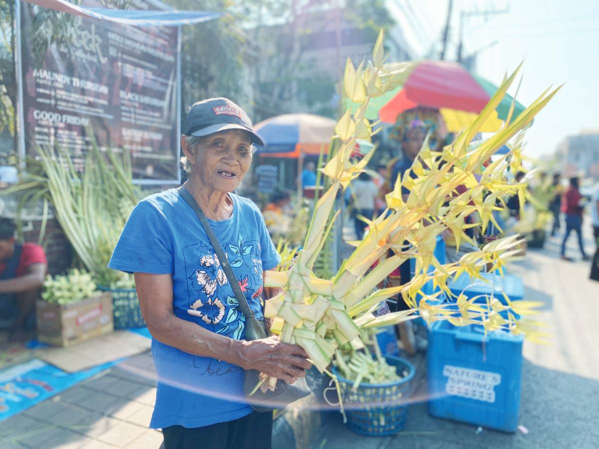 Maria Rita Bantillo, 74 years old, continues her decades-long tradition of selling woven palm fronds or “lukay” outside San Sebastian Cathedral in Bacolod City every Palm Sunday, a quiet testament to faith, family and enduring Holy Week devotion spanning over 47 years. (Cesar Jolito III / WDJ photo)