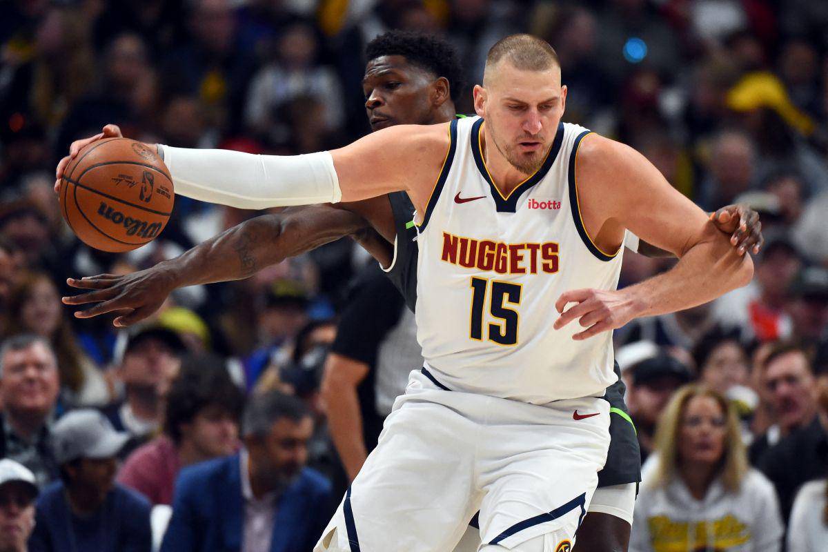 Denver Nuggets center Nikola Jokic (15) is fouled by Minnesota Timberwolves guard Anthony Edwards as he handles the ball. (Christopher Hanewinckel / Imagn Images via Reuters)