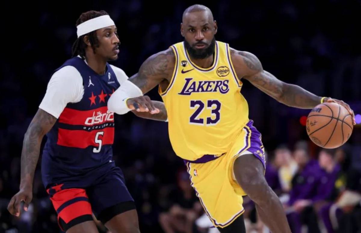 Los Angeles Lakers forward LeBron James (right) drives against Washington Wizards guard Jamir Watkins during the game. (Ryan Sun / AP photo)