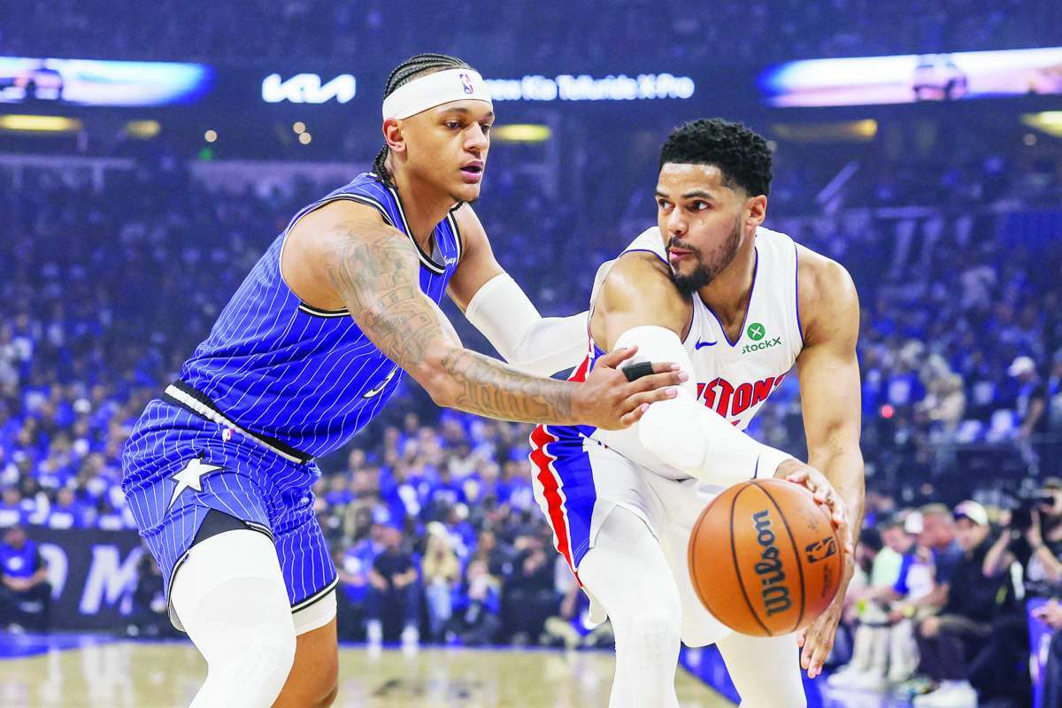 Detroit Pistons forward Tobias Harris (right) passes in front of Orlando Magic forward Paolo Banchero during Game 4 of the 2026 NBA playoffs. (Mike Watters / Imagn Images / Reuters)