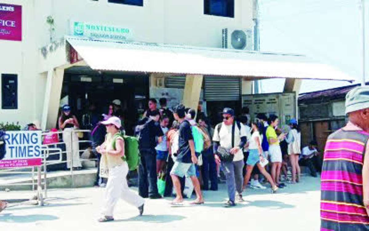 Passengers make their way through Siquijor port on Monday, April 20, 2026, while waiting to board vessels bound for Dumaguete City. The Coast Guard District Southern Visayas has deployed additional personnel to manage crowds and monitor vessel capacities following a surge in travelers over the weekend. (Coast Guard District - Southern Visayas photo)
