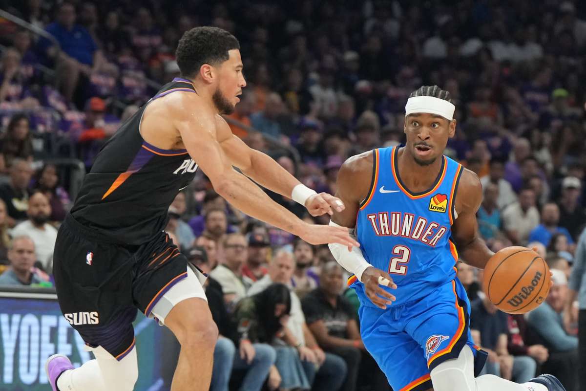 Oklahoma City Thunder guard Shai Gilgeous-Alexander (right) drives around Phoenix Suns guard Devin Booker during Game 3 of the 2026 NBA playoffs. (Rick Scuteri / Imagn Images / Reuters)