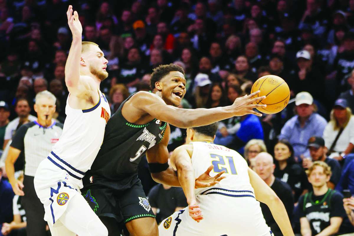 Denver Nuggets forward Spencer Jones (right) fouls Minnesota Timberwolves guard Anthony Edwards (center) as forward Christian Braun defends. (Bruce Kluckhohn / Imagn Images / Reuters)