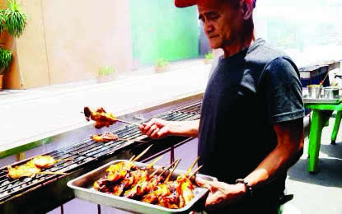 A cook grills chicken inasal during the opening of the Bacolod Chicken Inasal Festival at Manokan Country in May 2025. The festival's sixth edition will be held on May 29 to 31, 2026. (PNA Bacolod / File photo)