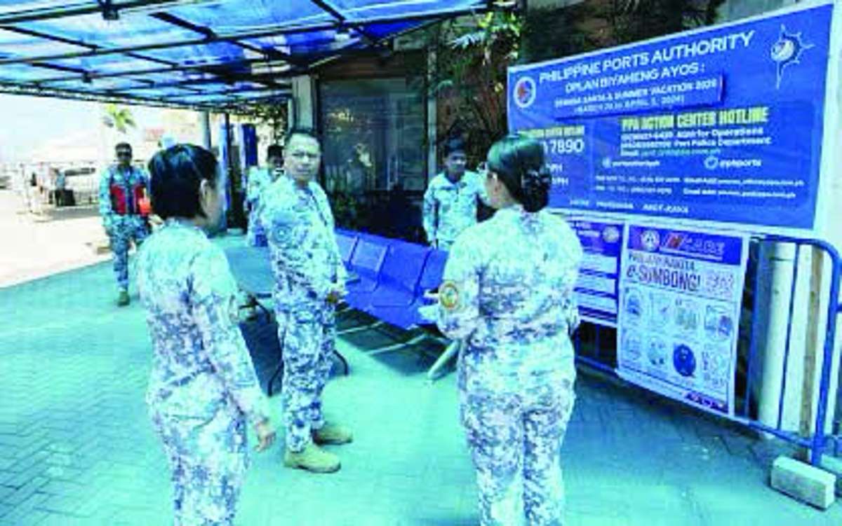 Commodore Christopher Auro, commander of the Coast Guard District Southern Visayas (center), checks on the deployment of personnel at the Dumaguete City port in Negros Oriental in this undated photo. Auro says the Coast Guard is on heightened alert following reports of suspected communist rebels arriving in Negros Oriental. (Coast Guard Station Negros Oriental / Facebook photo)