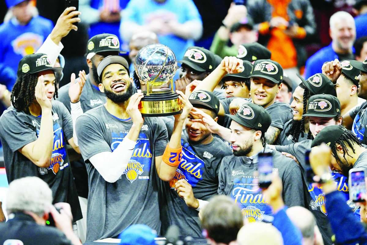 New York Knicks center Karl-Anthony Towns lifts the 2026 Eastern Conference trophy with teammates after defeating the Cleveland Cavaliers in Game 4 of the finals for the 2026 NBA playoffs. (David Richard / Imagn Images via Reuters)