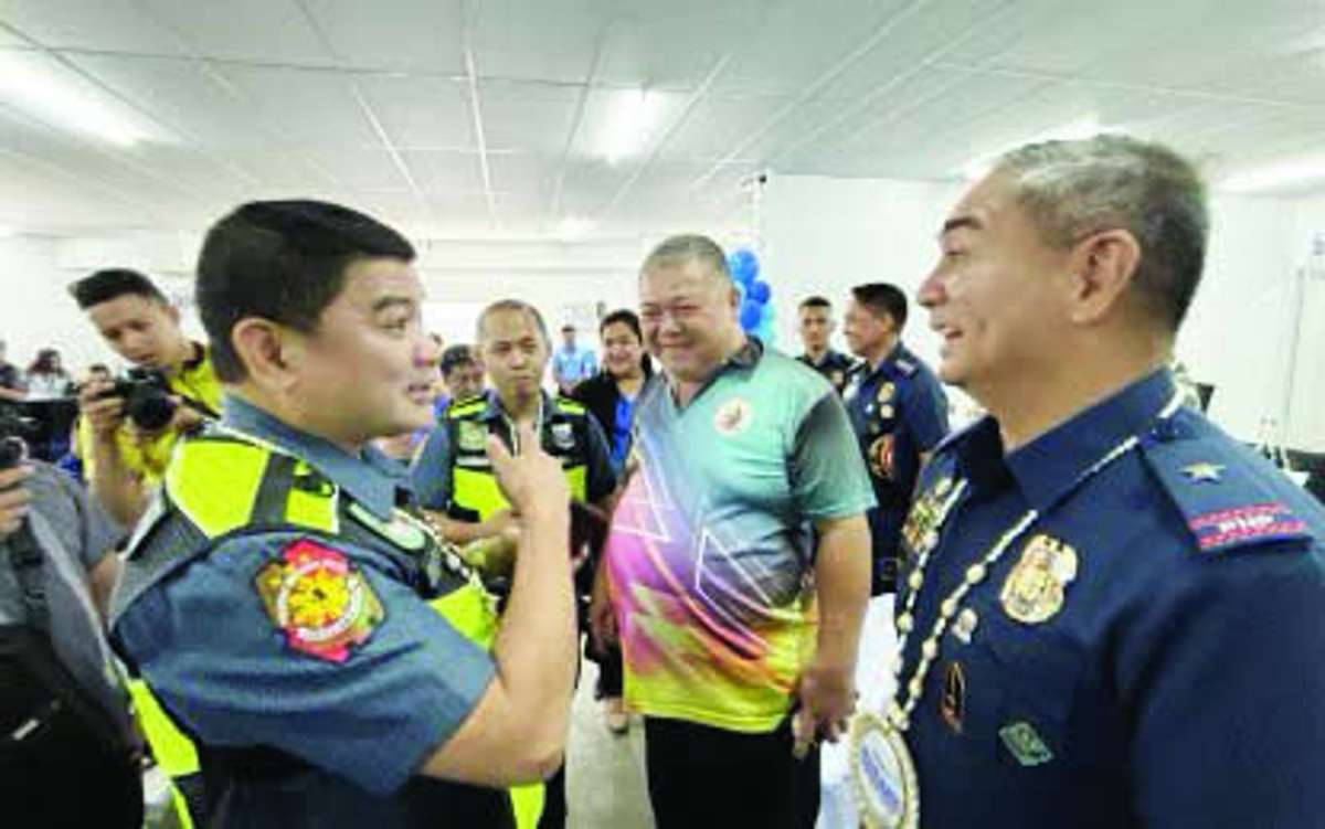 Negros Oriental officer-in-charge Police Director Colonel Timmar Alam engaged in a casual talk with Brigadier General Arnold Thomas Ibay, Police Regional Office in the Negros Island Region director, on Wednesday, May 6, 2026. Ibay says the Negros Island Region needs police officers with higher ranks to fill up vacant positions that require certain qualifications. (PNA photo)