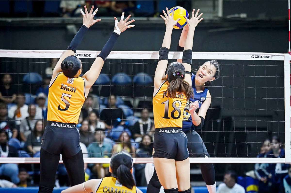 Negrense Arah Panique of the National University Lady Bulldogs scores against the defense of the University of Santo Tomas Golden Tigresses. (UAAP photo)