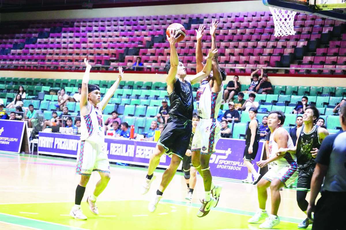 Kobe Monje of the Quezon City Black Bulls scores against the defense of Bacolod Masskara. (MPBL photo)