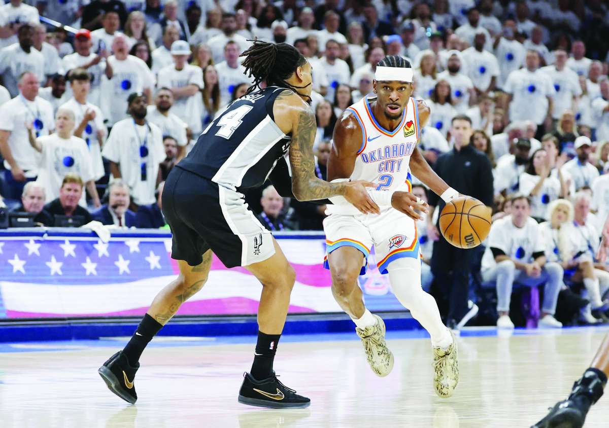 Shai Gilgeous-Alexander (right) drives against Devin Vassell during Game 5 of the Western Conference finals for the 2026 NBA playoffs. (Alonzo Adams / Imagn Images / Reuters)