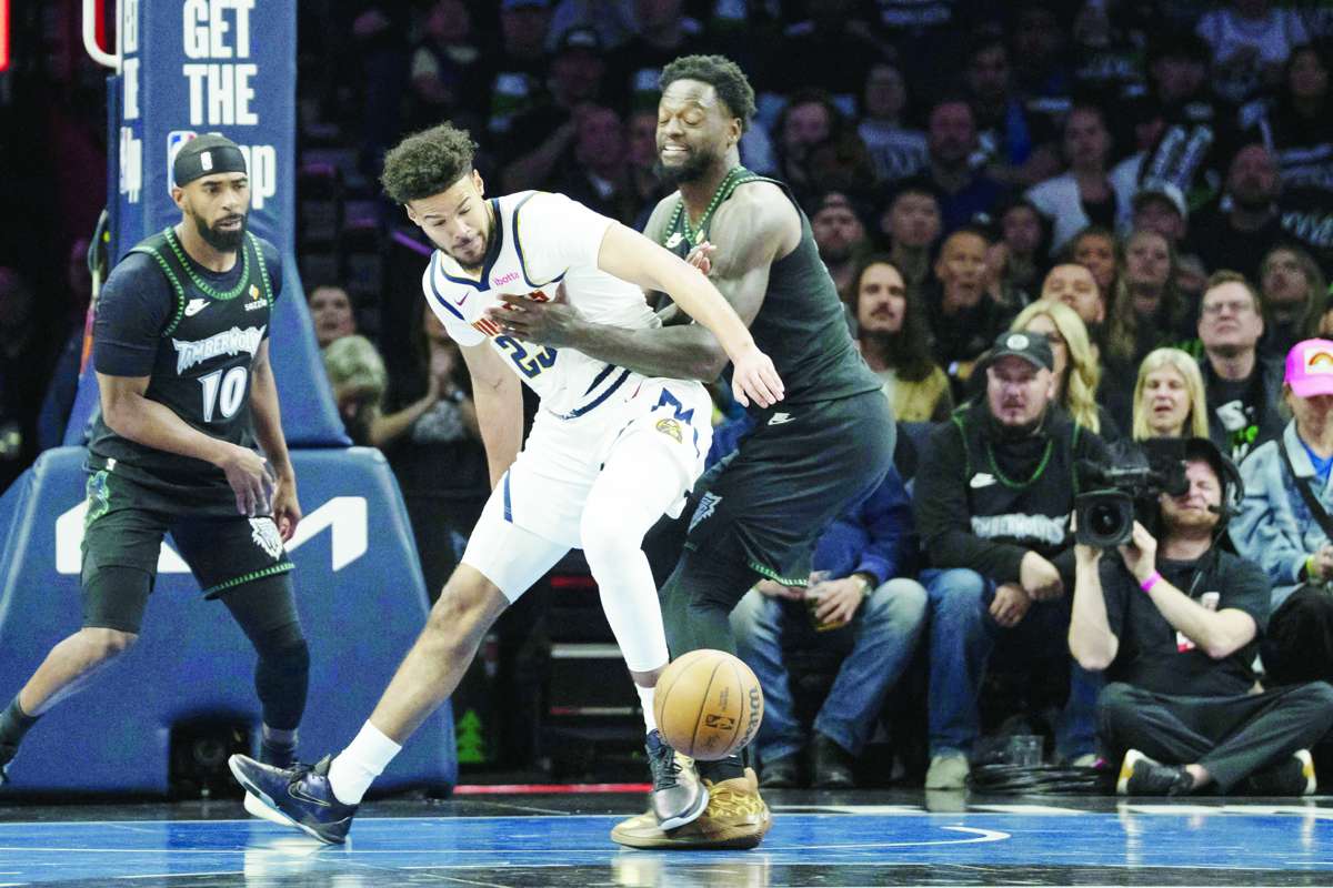 Cameron Johnson (center) looses the ball as Julius Randle (right) plays defense during Game 6 of the 2026 NBA playoffs. (Jesse Johnson / Imagn Images / Reuters)
