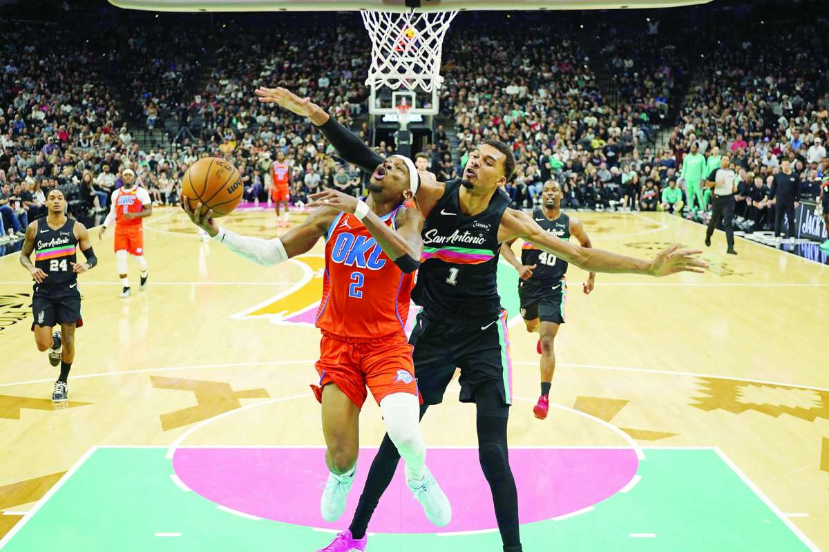 Oklahoma City Thunder guard Shai Gilgeous-Alexander driving to the basket past San Antonio Spurs forward Victor Wembanyama. (Scott Wachter / Imagn Images)