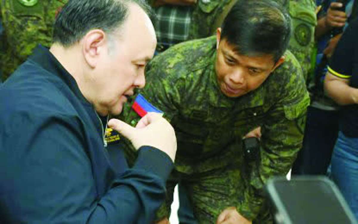 Lt. Colonel Eric Alfonso, commander of the Philippine Army’s 79th Infantry Battalion, in a discussion with Defense Secretary Gilberto Teodoro, Jr. during the official’s visit to the wake of slain Private First Class Johnrey Brasil at a memorial chapel in Sagay City on Wednesday, June 3, 2026. The Philippine Army's 79th Infantry Battalion is pursuing another fugitive New People's Army rebel identified as Alejandro "Kier" Montoya in continuing security operations in northern Negros. (Sagay City Information and Tourism Office photo)