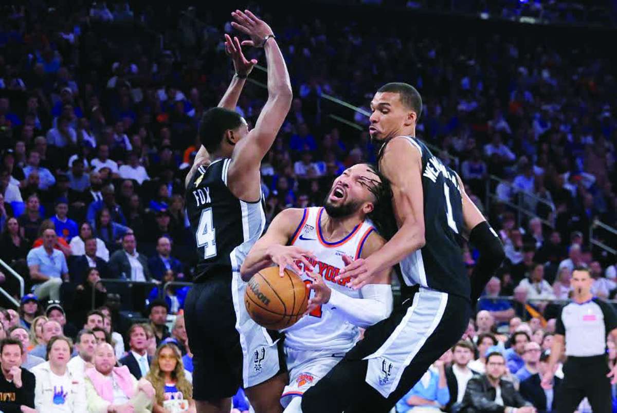 San Antonio Spurs forward Victor Wembanyama (right) and guard De'Aaron Fox (left) defend against New York Knicks guard Jalen Brunson in Game 4 of the 2026 NBA finals. (Brad Penner / Imagn Images via Reuters)