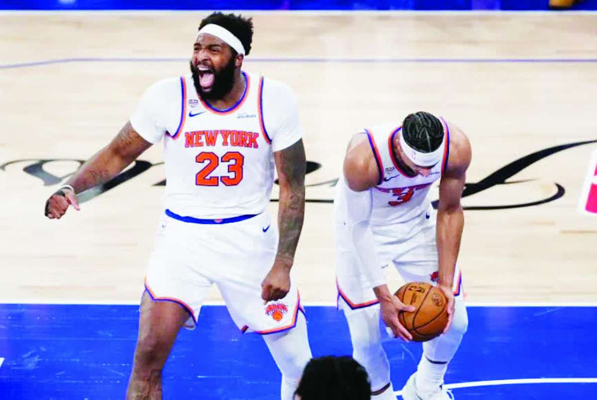 New York Knicks center Mitchell Robinson (left) and guard Josh Hart celebrate after Game 4 of the NBA finals against the San Antonio Spurs. (Ross D. Franklin / AP photo)